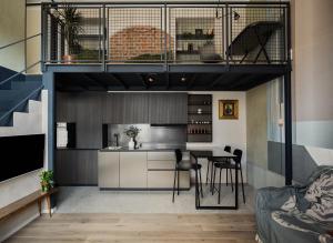 a loft apartment with a kitchen and a dining area at Bellevue Bocconi Suite in Milan