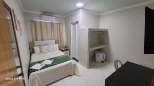 Postel nebo postele na pokoji v ubytování Hotel Hiperion Maringá