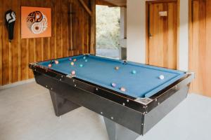 a pool table with balls on it in a room at Cabana Refúgio Coqueiral in Rio Forcação