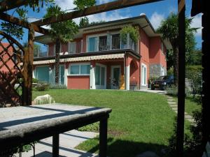a house with a yard with a bench in front of it at Sunny Villa with Terrace in Comerio +32 photos