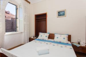 a bedroom with a large white bed with a window at Dubrovnik OLD PORT Accommodation in Dubrovnik