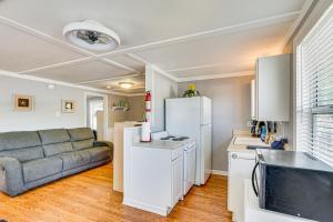 a living room with a couch and a kitchen at Private Dock on Fishing Cove Camdenton Getaway in Camdenton +18 photos
