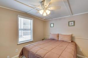 a bedroom with a bed and a ceiling fan at Private Dock on Fishing Cove Camdenton Getaway in Camdenton