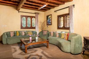 a living room with two couches and a coffee table at Arnaoon Village in Batroûn