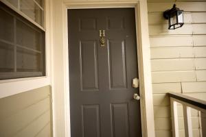 a door to a house with a gray door at Northtown Apartments 12h I Comfy 2 Bed 2 Bath in Jackson