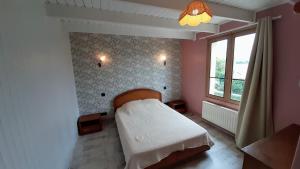 a small bedroom with a bed and a window at Maison cosy & jardin privé Plages à 5 min in Tourville-sur-Sienne +14 photos