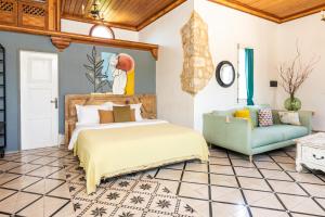 a bedroom with a bed and a couch at Arnaoon Village in Batroûn +188 photos