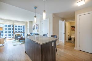 an open living room with a kitchen and a living room at Luxury Apt Near Downtown in Stamford +4 photos