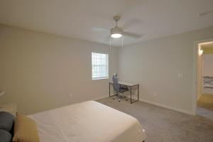 a bedroom with a bed and a desk and a ceiling fan at Northtown Apartments 10a I Spacious 1 Bed 1 Bath in Jackson +11 photos