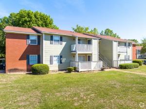 a large house with a lawn in front of it at Northtown Apartments 7e I Comfy 2 Bed 2 Bath in Jackson