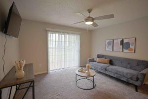 a living room with a blue couch and a table at Northtown Apartments 7e I Comfy 2 Bed 2 Bath in Jackson