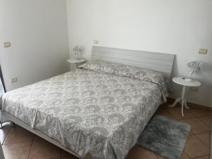 a bedroom with a bed and two night stands at Casa vacanze La Gioia in Sestu