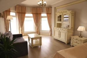 a living room with a couch and a dresser at Sapsan in Ternopilʼ