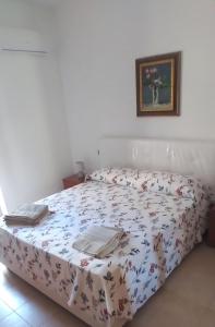 a bedroom with a bed in a white room at Mazzeo in Santa Maria di Castellabate +13 photos