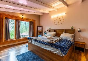 a bedroom with a bed and a large window at Priory Cottage Heritage Haven in Nainital