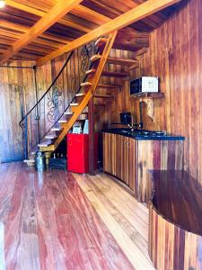 a room with a staircase in a wooden building at Villa montebello Pousada Tanoeiro in Monte Belo +8 photos