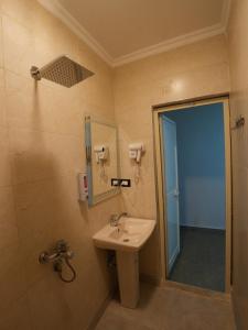 a bathroom with a sink and a mirror at Montana Hotel in Cairo +97 photos