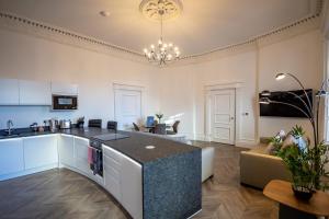 a kitchen and living room with a island in a room at Luxury 1 bedroom ground floor apartment in Plymouth