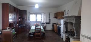 a kitchen with a table with chairs and a window at Collina delle Rose in Bagnoregio