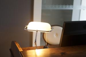 a lamp sitting on top of a wooden table at Charming Blue in Vila do Porto
