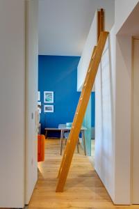 a wooden staircase in a room with a blue wall at 5 Brewhouse by Pureserviced in Plymouth +33 photos
