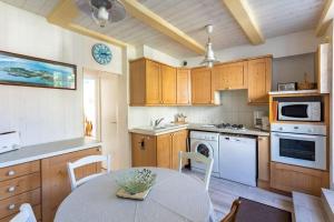 a kitchen with a table and a kitchen with a stove at Ker Roz - Belle maison 3 chambres- Proche Mer-Port in Cancale