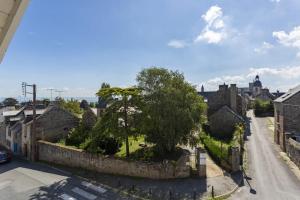 a view of a town with a stone wall at Ker Roz - Belle maison 3 chambres- Proche Mer-Port in Cancale