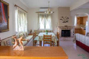 a living room with a table and a dining room at Emily's Home in Epanomi