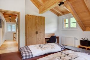 a bedroom with a bed and a wooden door at Schonzeit Chalet in Bernau im Schwarzwald