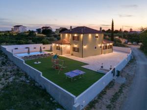 an aerial view of a house with a yard at Beautiful Villa Rustica with pool in Vrana