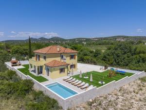 an aerial view of a house with a swimming pool at Beautiful Villa Rustica with pool in Vrana