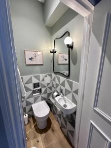 a bathroom with a toilet and a sink at Edenhurst By Pureserviced in Plymouth