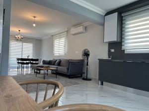 a kitchen and living room with a couch and a table at Villa Royal Sun Elite 29 by MyGuest Cyprus in Iskele