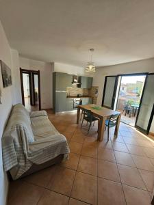 a living room with a couch and a table at Green Home in Valledoria