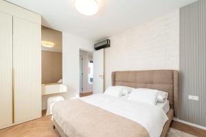 a bedroom with a large white bed with white pillows at La Vir deluxe- Gold in Vir +68 photos