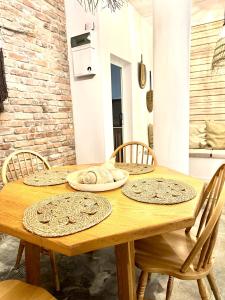 a wooden table with chairs and plates on it at Terra Massa in Sinemorets