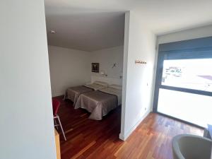 Ένα ή περισσότερα κρεβάτια σε δωμάτιο στο Espacio San Juan de la Cruz