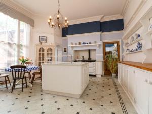 a large kitchen with a white island in a room at Ismay Lounge Apartment- Titanic Interest in Liverpool