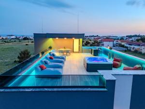 a house with a swimming pool with blue furniture at La Vir deluxe- Gold in Vir