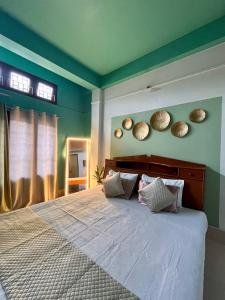 a bedroom with a bed with three mirrors on the wall at Townsville in Jorhāt