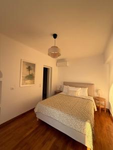 a bedroom with a bed and a pendant light at Anemoessa in Naxos Chora