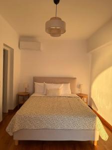 a bedroom with a bed and two night stands at Anemoessa in Naxos Chora +26 photos