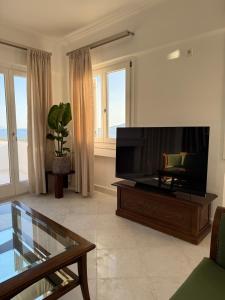 a living room with a large flat screen tv at Anemoessa in Naxos Chora