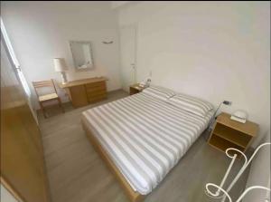 a bedroom with a bed and a table and a mirror at Loggia di Capo d'Arco - Goelba in Capo D'Arco +17 photos