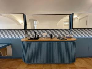 a counter with a sink in a room with mirrors at Starhost - Il Ricordo del Capitano in Atrani