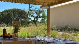 un tavolo con bicchieri di vino sopra con un campo di Braciosa a Coruche Altre 26 foto