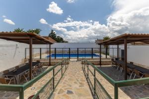 a view of a swimming pool with chairs and a fence at Callejon Del Pozo in Gálvez