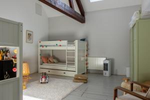 a childs room with a white bunk bed in it at Villa de 181m2 4 chambre avec piscine et stationnement in Tresserves
