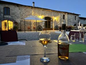a bottle of wine sitting on a table with a glass at La Grange in Yviers