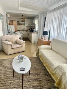 a living room with a couch and a table at Evangeo Seaview Apartment Epanomi in Epanomi